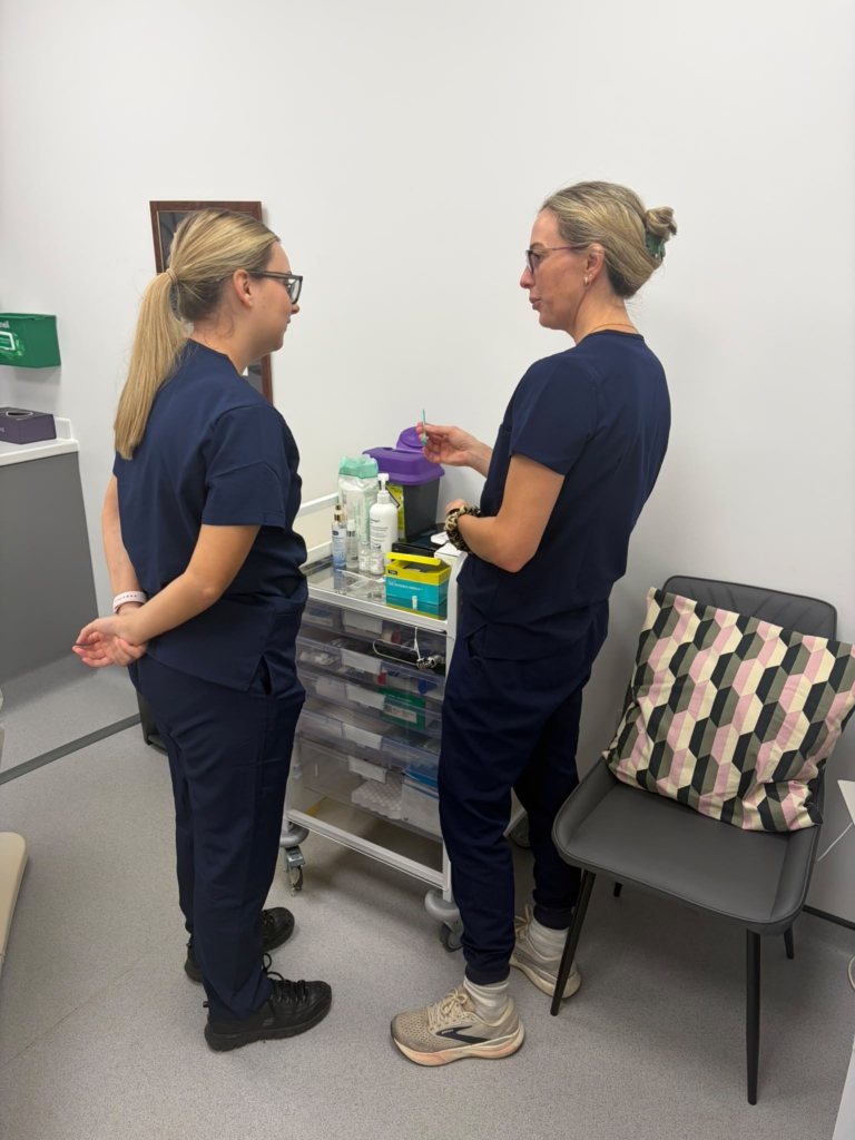 Trainer and delegate discussing treatment preparation