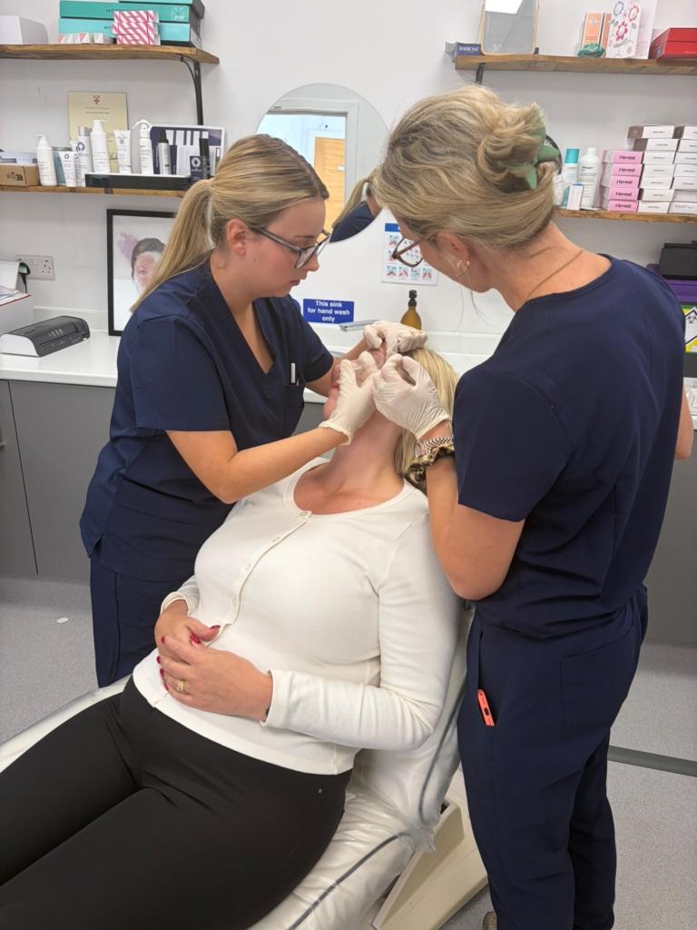Trainer guiding a delegate's injection technique