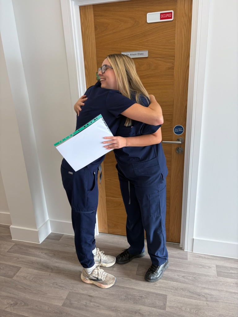 Trainer congratulating a delegate on completing the course