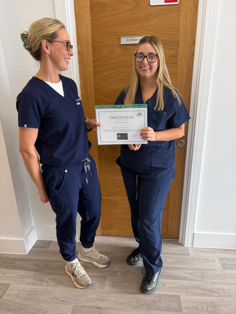 Trainer and delegate holding the course certificate